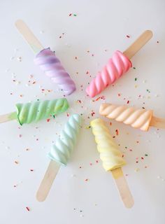 four colorful popsicles sitting on top of each other