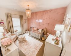 a baby's room with pink walls and furniture in the corner, including a crib