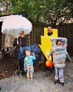 three adults and two children dressed up in costumes