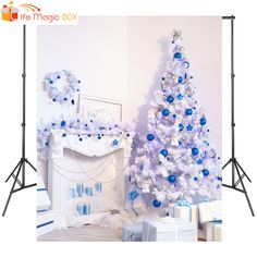 a white christmas tree with blue and silver ornaments