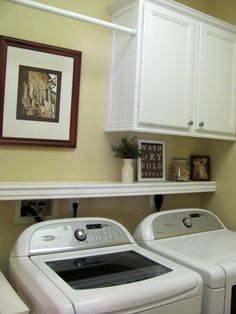 a white washer and dryer sitting next to each other in a laundry room