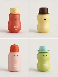 four different styles of baby bottles with faces painted on the lids and one has a straw hat