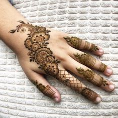 a woman's hand with hennap on it and some flowers in the middle