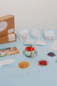 an assortment of items on a blue table with white paper and scissors, some are empty