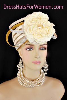 Ladies 1920's Style Flapper Art Deco Era Ivory Metallic Gold Pillbox Church Wedding Bridal Cocktail Hat. This Formal Straw Braid Hat Is Embellished With A Large Ivory Double Loop Bow Enhanced With Clear Acrylic Rhinestones, Accented With Two Metallic Gold Double Looped Bows. A Large Ivory Millinery Silk Flower With A Large Pearl Center Is Placed In The Center Of This Beautiful Custom Made Bow.  Four Rows Of Rhinestones Encircle The Crown Of This Fashion Wedding Headpiece. This Designer Hat Is Suited For A Bride To Be On Her Wedding Day Or For A Wedding Guest. A Beautiful Dress Hat To Wear To Church, Formal, Horse Races, The Kentucky Derby And Formals. This Dress Couture Hat Is Custom Made And Designed By Dress Hats For Women, https://dresshatsforwomen.com

Crown Measures:   This Is A Vinta Double Loop Bow, Special Occasion Hats, Mother Of The Bride Hats, Flapper Art, Custom Made Hats, Occasion Hats, Bridal Fascinator, Couture Hats, Bridal Hat