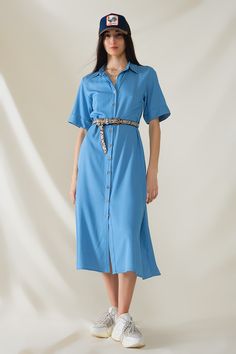 Introducing our Blue Maxi Shirt Dress with Polo Collar, a versatile and stylish piece perfect for spring and summer. This dress features a relaxed fit and maxi length, offering both comfort and elegance for any occasion.  Crafted from lightweight woven fabric, this dress is breathable and airy, making it ideal for warmer weather. The polo collar adds a touch of sophistication, while the button-up closure and short sleeves provide a classic and timeless look.  The dress comes with a belt made from the same fabric, allowing you to cinch the waist for a more defined silhouette or wear it loose for a relaxed vibe. Whether you're heading to a casual outing, a beach vacation, or a weekend brunch, this dress is sure to make a statement.  The model is wearing size S, with measurements of 33-24-36 Maxi Shirts, Skirt Jumpsuit, Maxi Shirt Dress, Blue Maxi, Romper Pants, Polo Collar, Sweater Coats, Hat Hairstyles, Woven Fabric