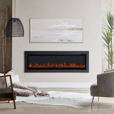 a living room with a couch and chair in front of a fire place that is on the wall