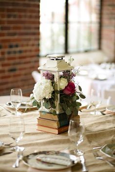 a table with flowers and books on it