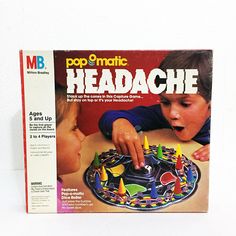 a magazine cover with a child playing with a toy on the table and an advertisement for pop - o - matic headache