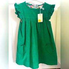 Perfect Dress For Spring, St Patrick’s Day, Easter! Adorable Girl’s Green Dress With Heart Pockets. Beautiful Floral Detailing On The Inside (Underneath Lining & Pocket Lining) Above Knee Length Back Button Placket Opening Main 100% Cotton Lining 65% Polyester 35% Cotton Machine Washable Green Long Sleeve Dress For Playtime, Green Casual Dress For Playdate, Casual Green Dresses For Playdate, Green Short Sleeve Playwear Dress, Green Cotton Dress For Babies, Green Casual Dress For Playtime, Green Cotton Dress For Dress-up, Green Ruffled Dress For Play, Cute Green Dresses For Playtime