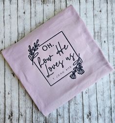 This listing is for a short sleeve lilac colored t-shirt with embroidery. Embroidered Lavender Cotton Top, Embroidered Cotton Lavender Top, Purple Cotton Tops With Embroidered Text, Purple Short Sleeve T-shirt For Gift, He Loves Us, Faith Tshirts, How He Loves Us, Christian Shirt, Lilac Color