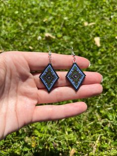 A Staple design in my shop! From the April Collection - 🌎  This pair of hand beaded earrings was made with an Earthy color pallet using blue, green, black and bronze beads.  This pattern is a signature design in my shop - the perfect size for humans who don't want to wear large jewelry. My inspiration came from the land and sea, the forest and water, and the stars mixed in the dark nighttime sky.  These earrings are so comfortable to wear - lightweight and easy to wear. 💧All findings are silver plated and nickel free. 🤍Made with love using size 11/0 beads.  Earrings are 2.25" long including the ear hooks. Turquoise Beaded Earrings With Black Beads As Gift, Green Beaded Earrings With Black Beads For Gift, Green And Black Beaded Earrings For Gifts, Hand Beaded Earrings, Nighttime Sky, Land And Sea, Beaded Earrings Patterns, Beads Earrings, Large Jewelry