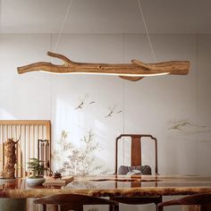 a dining room table with chairs and a wooden beam hanging from the ceiling