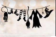 the silhouettes of witches and cats are hanging on a clothes line with halloween decorations