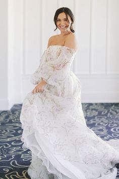 a woman in a white dress posing for the camera