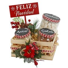 a basket filled with lots of food next to a sign that says feliz navidad