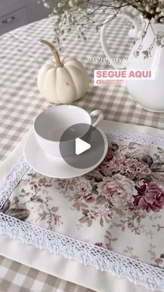 a table topped with white dishes and flowers