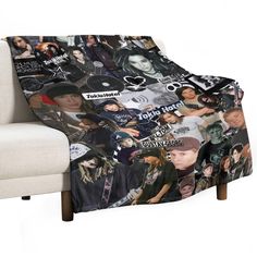 a chair with a blanket on it covered in photos and stickers, sitting next to a white couch