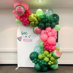 there is a bunch of balloons in the shape of a watermelon on display