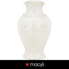 a white vase with an ornate design on it