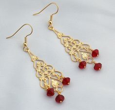 Beautiful high sparkle deep red Swarovski crystals swing from a gold tone filigree chandelier and gold tone fish hook ear wires. Perfect for the holidays with an approximate 2 1/4 inch drop, these earrings will be fun and a little sassy to wear to any party or event. We enclose all jewelry in a cotton lined jewelry gift box. Free shipping via USPS priority mail is included with purchase. Beading Inspiration, Earrings Chandelier, Holiday Earrings, Rock Jewelry, Earrings Christmas, Holiday Earring, Gemstone Jewelry Handmade, Earrings Red, Swarovski Crystal Earrings