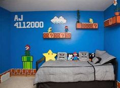 a bedroom with blue walls and mario bros decorations on the wall, as well as a bed