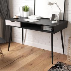 a black and white desk with a mirror, lamp and chair in front of it