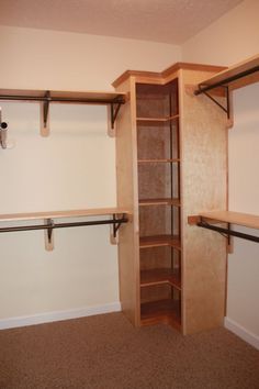 an empty room with some wooden shelves and white walls