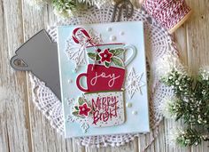 a close up of a card on a doily with flowers and yarn in the background