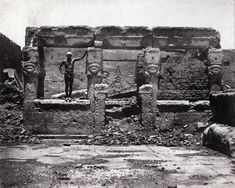 an old black and white photo of some statues