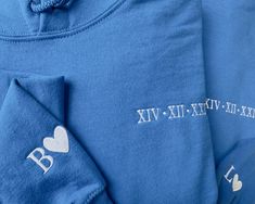 "Embroidered Initials Hoodie, Custom Roman Numeral Couple Anniversary Hoody, Personalised Special Date Matching Initial with Heart Sweatshirt Looking for a high-quality hoodie that's both comfortable and stylish? Our Custom Embroidered Hoodies, made from a blend of 50% polyester and 50% cotton, are the perfect choice. Featuring Roman numerals and personalized embroidery, they make a great gift for couples or for special occasions like birthdays and anniversaries. With a cozy brushed effect and a range of sizes available, these hoodies are sure to become a beloved wardrobe staple. Specifications: Our specialty lies in bringing your designs, logos, pictures, and imaginations to life on various apparel items in a visually appealing way. We take pride in delivering top-notch quality and value Couple Anniversary, Matching Hoodies, Personalized Matches, Embroidered Initials, Couples Anniversary, Heart Sweatshirt, Personalized Embroidery, Gift For Couples, Roman Numeral