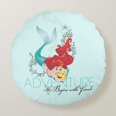 a round pillow with the words adventure written on it and an image of ariel from the little mermaid