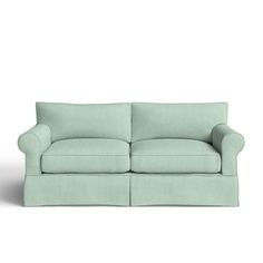 a light green couch sitting on top of a white floor