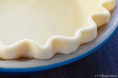 an uncooked pie crust sitting on top of a blue plate