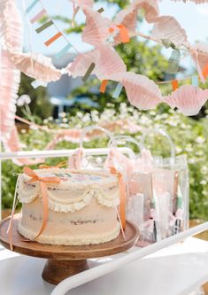 a cake sitting on top of a wooden table next to some flags and bunting