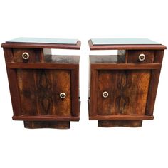 a pair of wooden nightstands with glass top on each side and one drawer in the middle