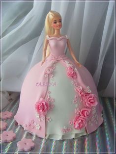 a barbie doll cake with pink roses on it