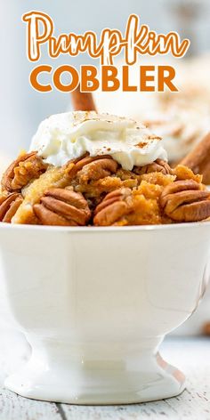 pumpkin cobbler with whipped cream and pecans in a white bowl