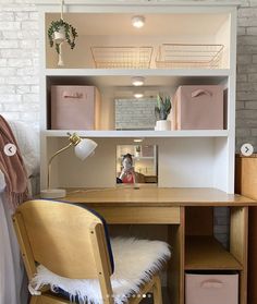 a wooden chair sitting in front of a desk with drawers and shelves on top of it