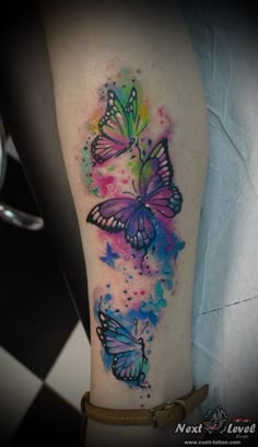 colorful watercolor tattoos with butterflies on the arm