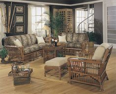 a living room filled with furniture on top of a hard wood floor covered in lots of windows