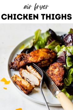 chicken thighs on a white plate with lettuce and carrots next to the words air fryer chicken thighs