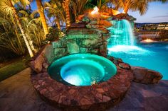 a large pool with a waterfall next to it