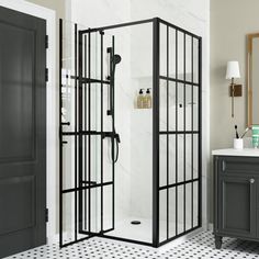 a black and white tiled bathroom with a walk in shower