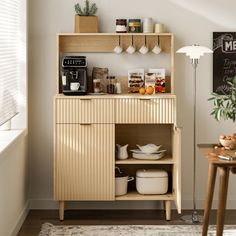 a kitchen area with a wooden cabinet and coffee maker