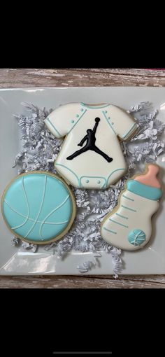 decorated cookies in the shape of baby's feet and sports gear are on display