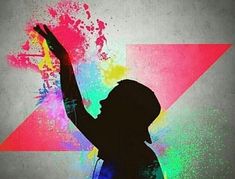 a girl with her arms up in the air and colored paint splatters all over her body