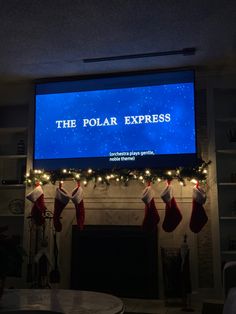 the polar express is lit up with christmas stockings and stocking hanging from the mantel