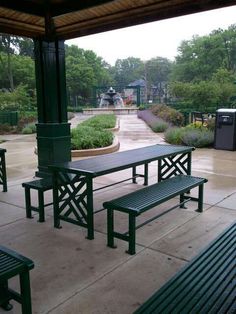 the benches are empty on the patio in the rain