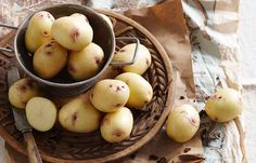 a bowl filled with potatoes sitting on top of a table